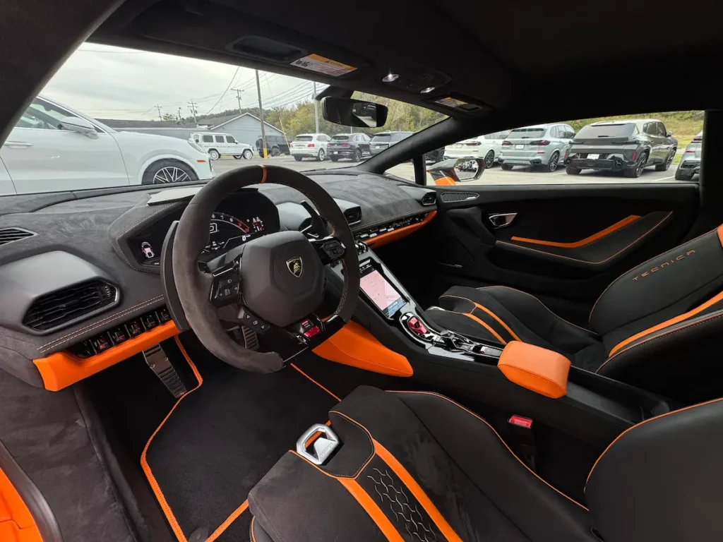2023 Lamborghini Huracan interior with orange accents and sport seats