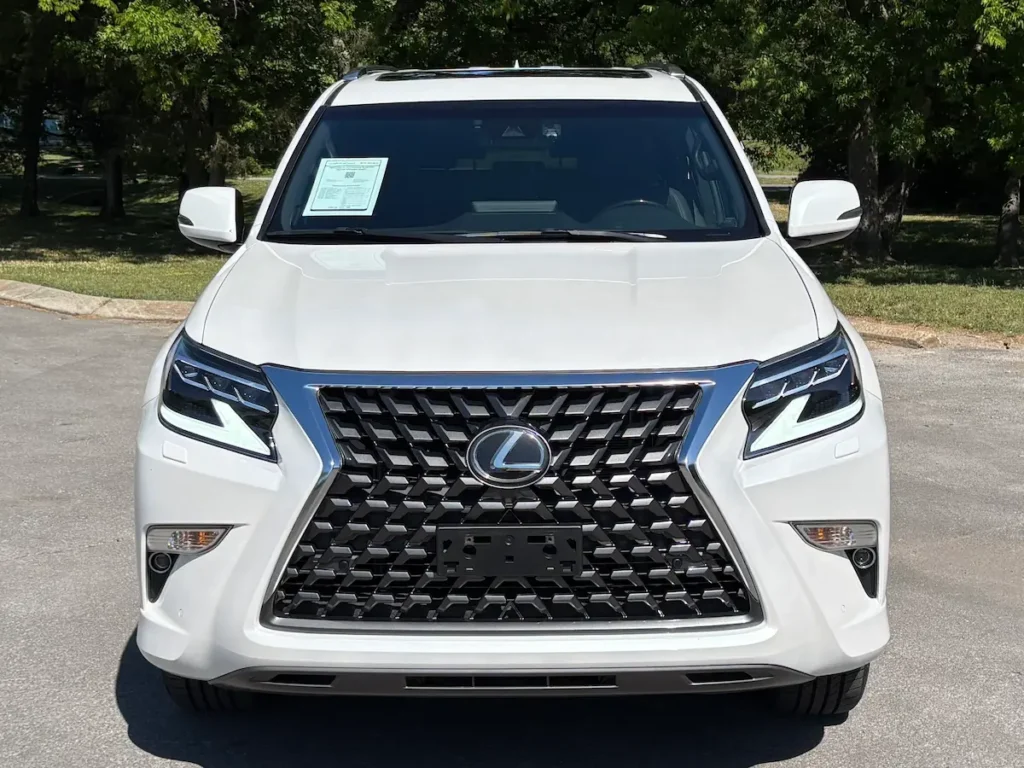 Front view of a white 2023 Lexus GX 460 with the Lexus spindle grille and LED headlights.