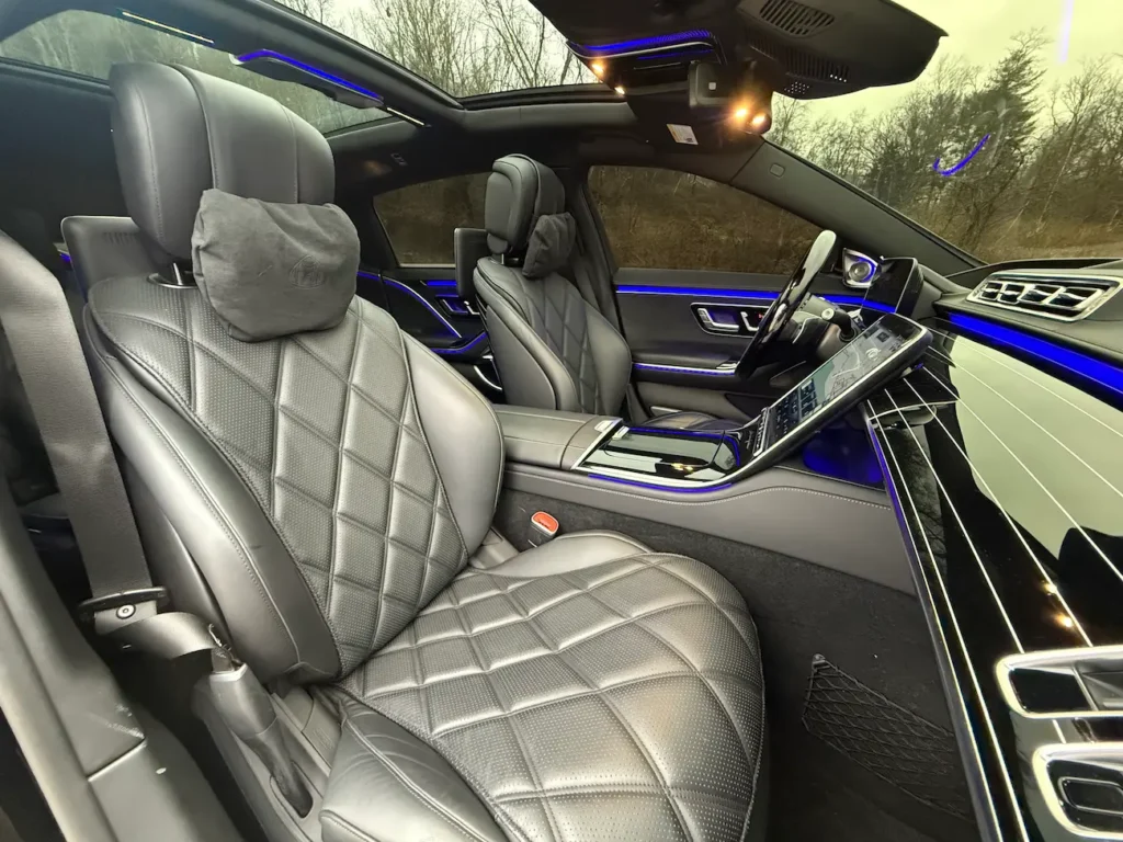 2023 Mercedes-Benz S680 Maybach interior with quilted leather seats, ambient lighting, and touchscreen controls.