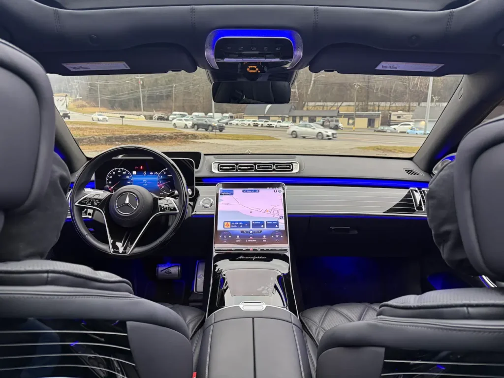 Driver’s view of 2023 Mercedes-Benz S680 Maybach dashboard with digital cluster and OLED central display.