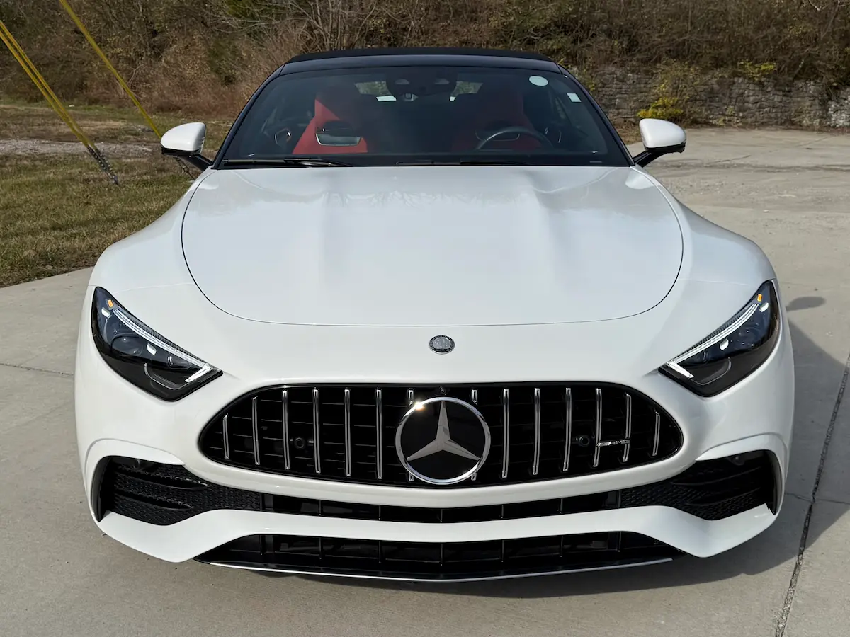 Front view of a white 2023 Mercedes-AMG SL43 with AMG grille