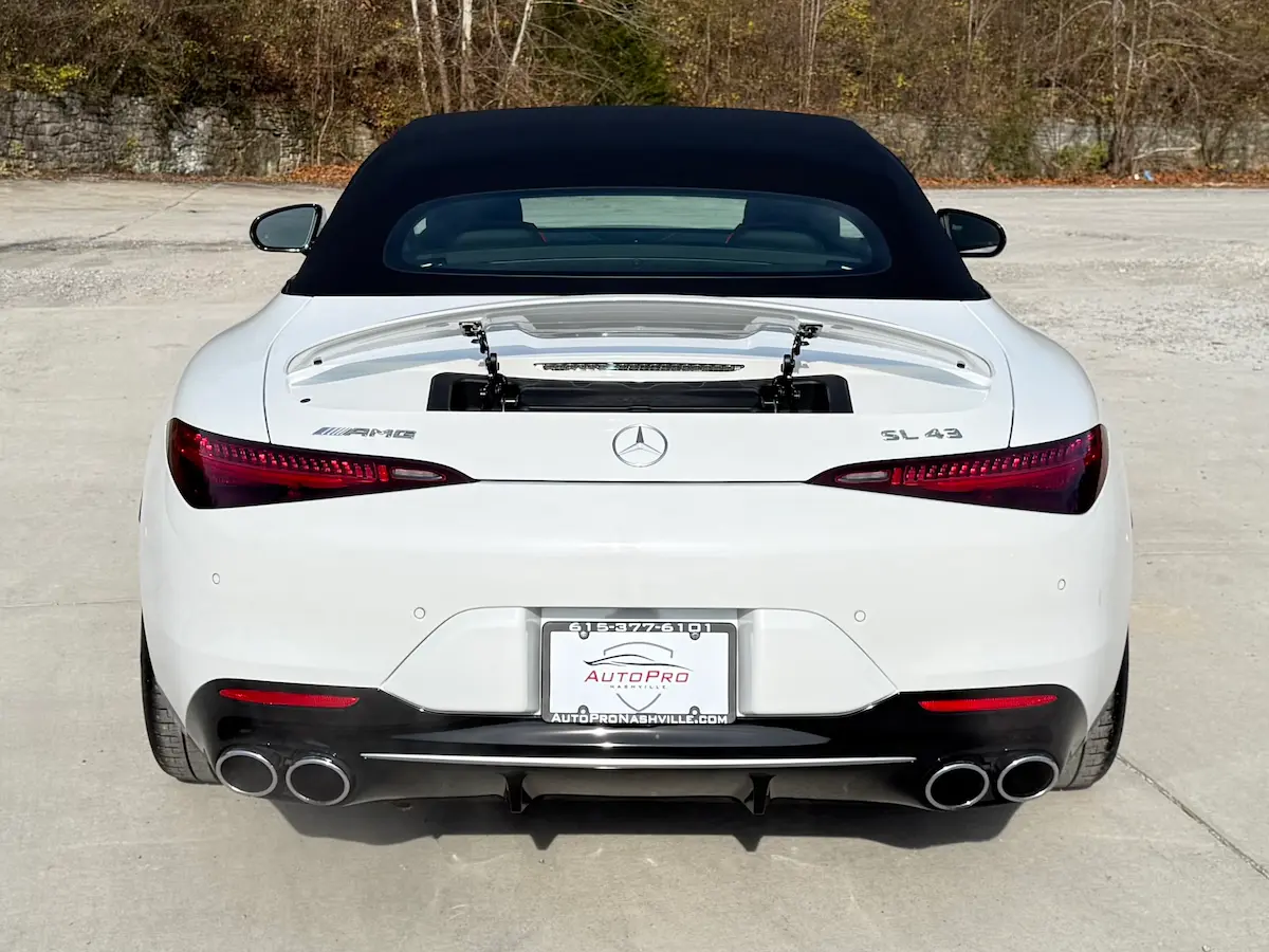 Rear view of a white 2023 Mercedes-AMG SL43 with fabric soft top