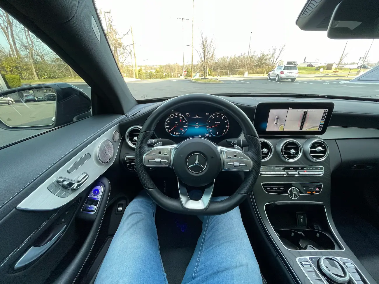 Driver’s cockpit of 2023 Mercedes-Benz C 300 Coupe with digital display and leather-wrapped steering wheel.