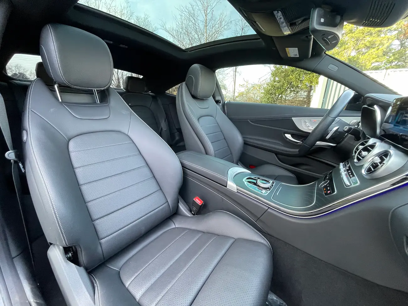 Front seats of 2023 Mercedes-Benz C 300 Coupe featuring black leather upholstery and modern console layout.