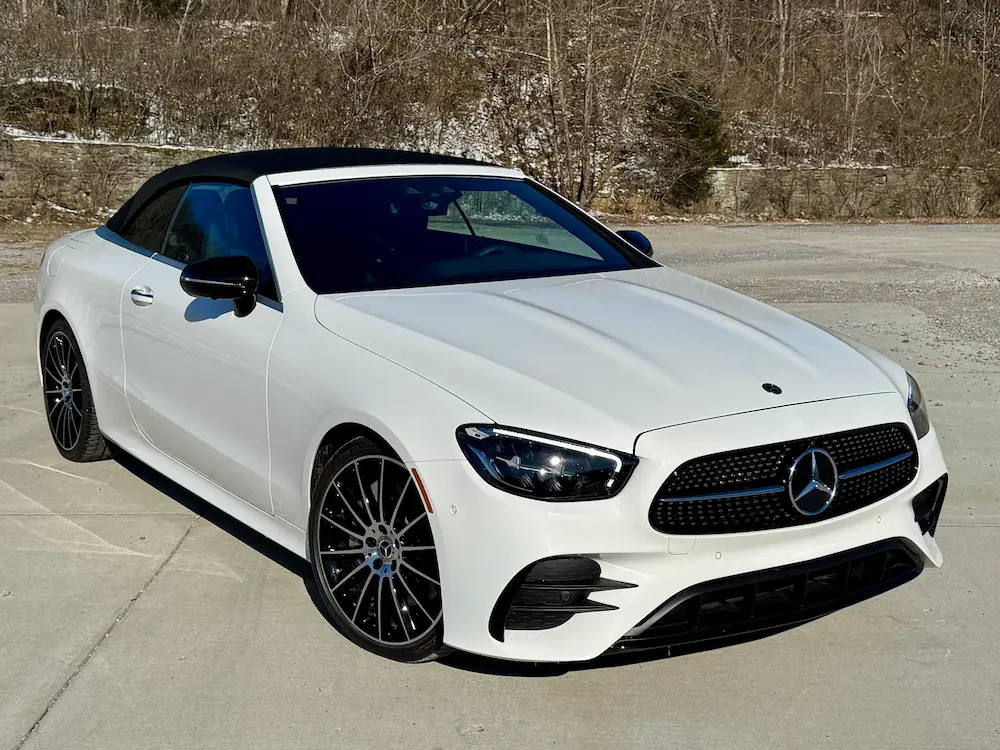 2023 Mercedes-Benz E 450 Cabriolet in Polar White with AMG Line styling, multi-spoke alloy wheels, and black soft-top roof.