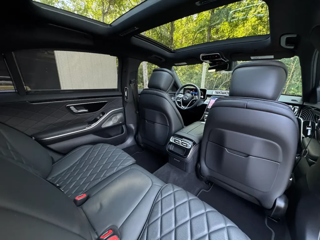 Rear seating area of the 2023 Mercedes-Benz S500 showing legroom and ambient lighting.