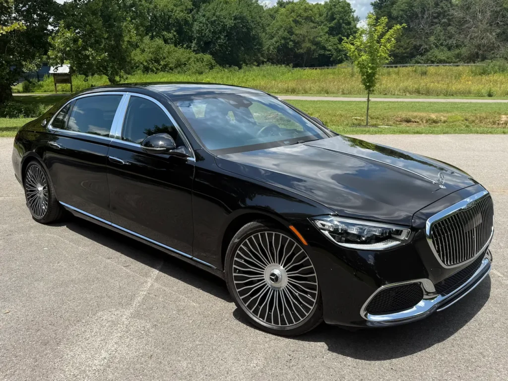 2023 Mercedes-Benz S580 Maybach in black showing front design with chrome grille and signature multi-spoke wheels.