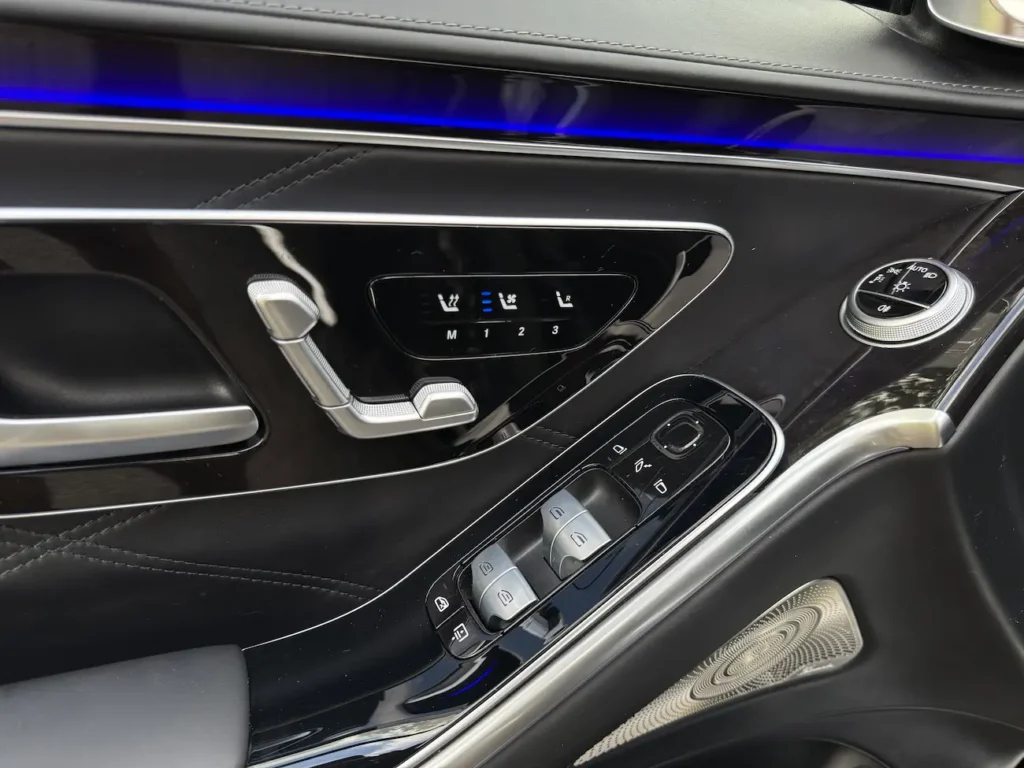 Close-up of 2023 Mercedes-Benz S580 Maybach door controls with heated seat settings and ambient lighting.