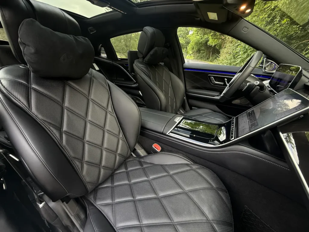 2023 Mercedes-Benz S580 Maybach front cabin with quilted leather seats, touchscreen display, and panoramic roof.