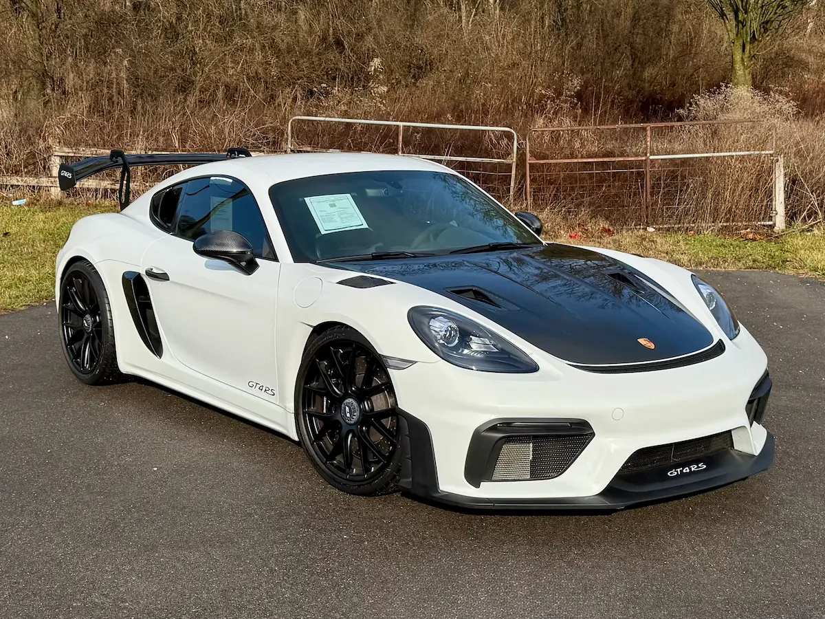 White 2023 Porsche 718 Cayman GT4 RS with a carbon-fiber hood and rear wing