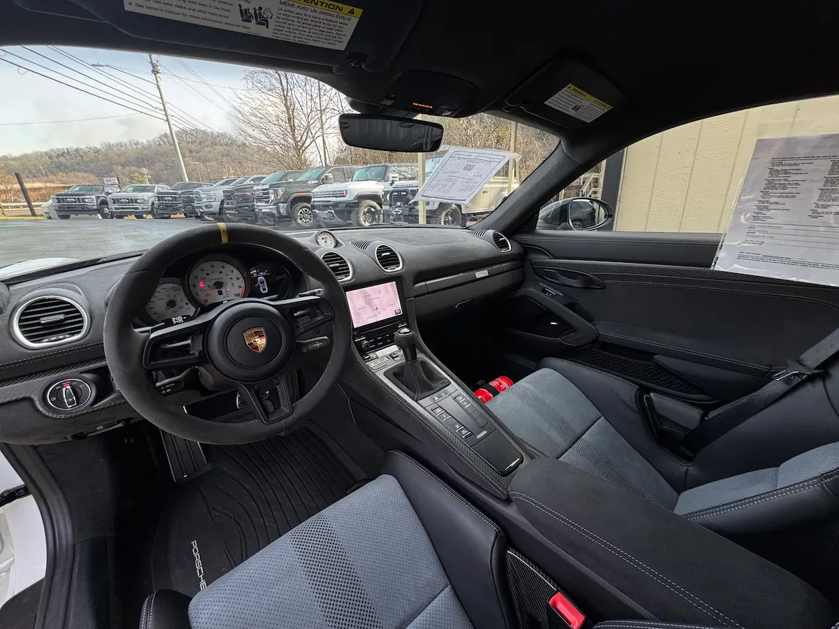 Black interior of a 2023 Porsche 718 Cayman GT4 RS with PDK controls
