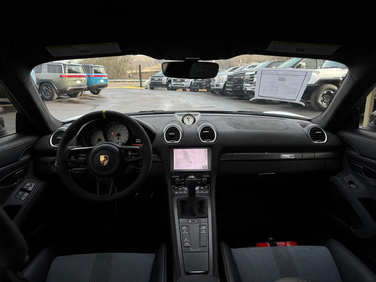 Driver-focused dashboard and cockpit of a 2023 Porsche 718 Cayman GT4 RS