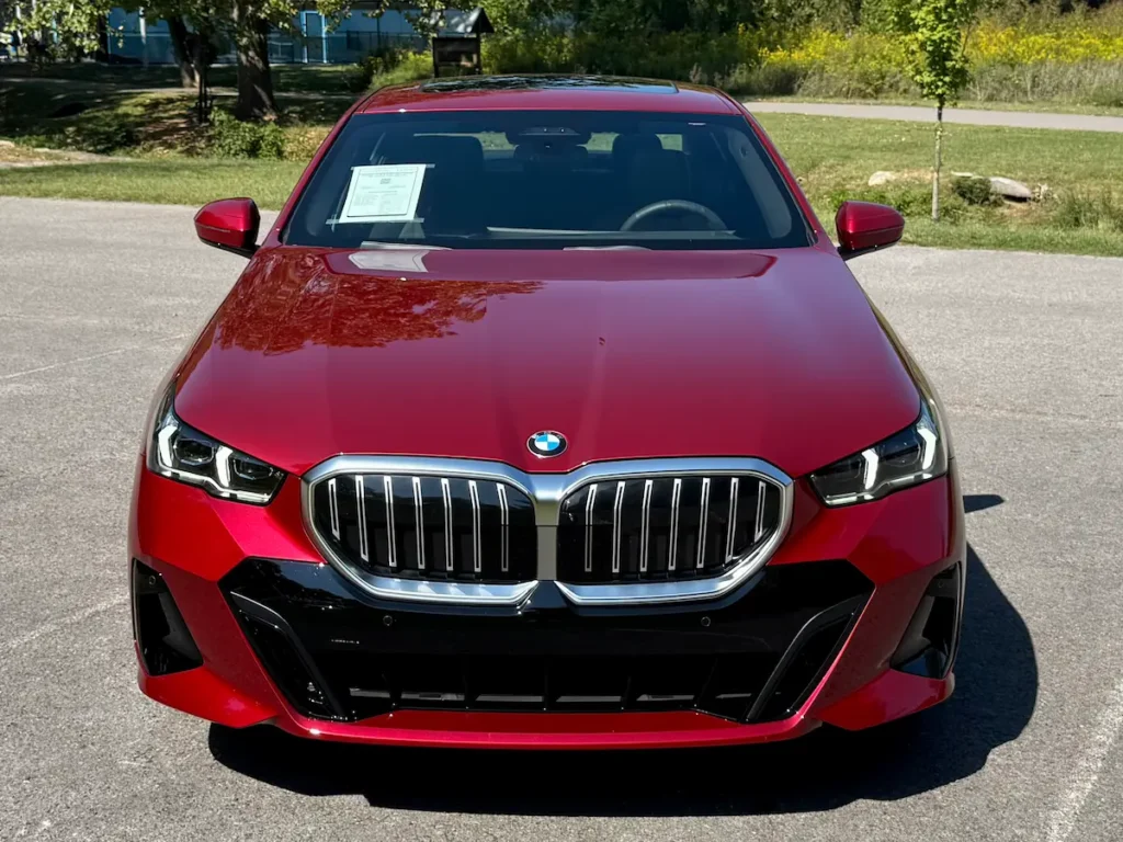 2024 BMW 530i red front view with M Sport package and signature kidney grilles.