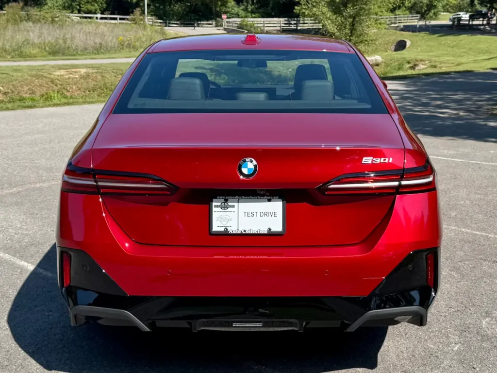 Rear view of 2024 BMW 530i showing LED taillights and modern trunk design.