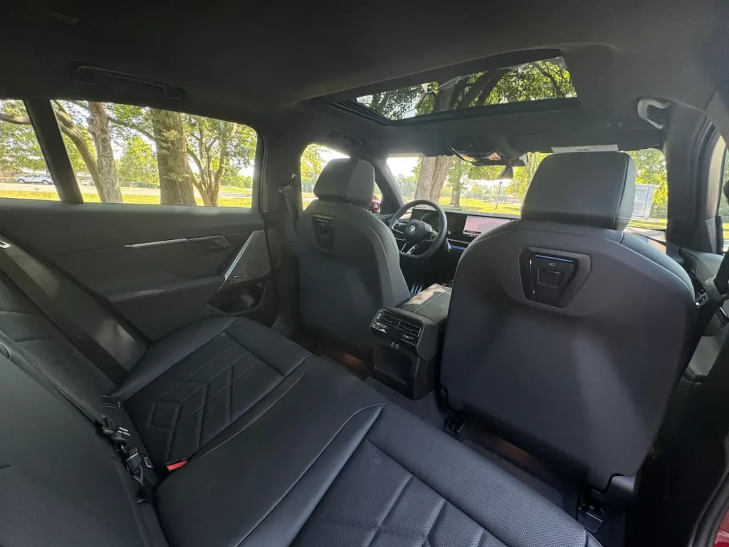 Rear seat interior of the 2024 BMW 530i showing spacious seating and premium materials.