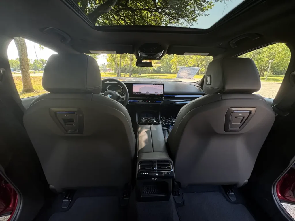 Interior of the 2024 BMW 530i showing the wide dashboard, curved display and modern controls.
