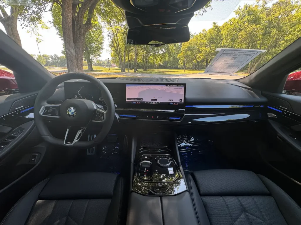 2024 BMW 530i interior with digital display, premium materials, and modern dashboard design.