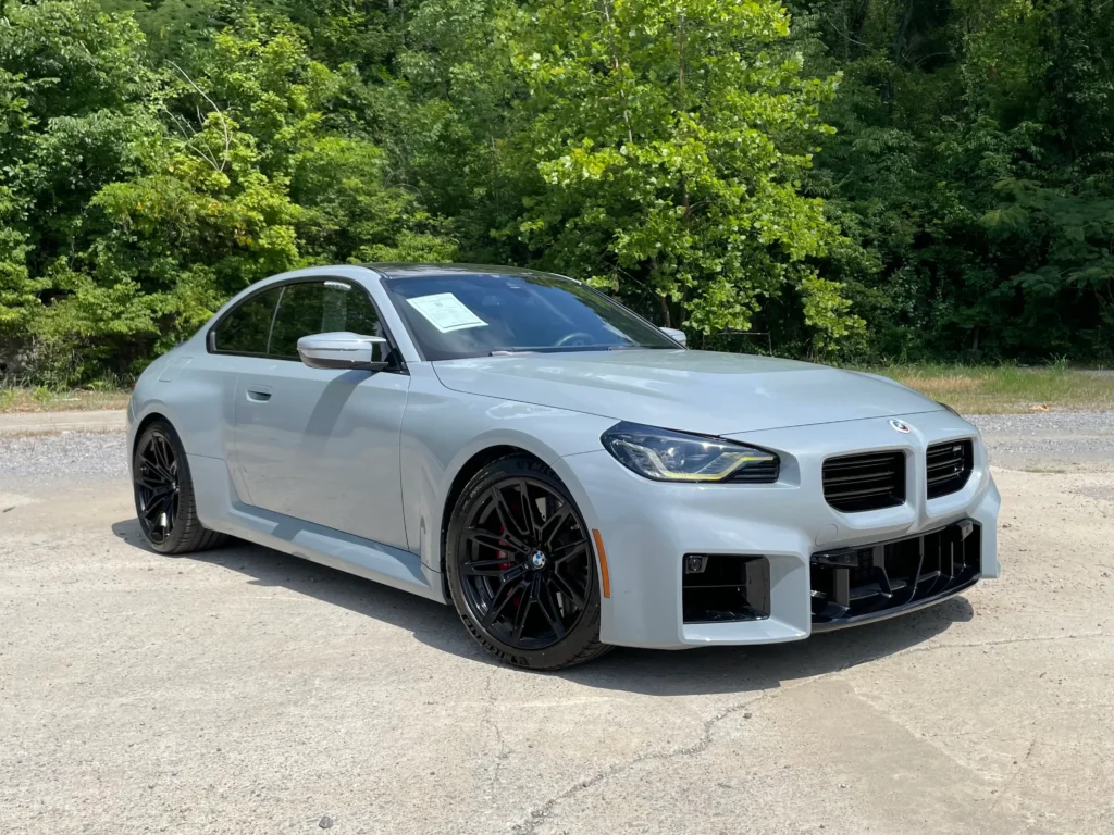 A sleek silver-gray 2024 BMW M2 on display at AutoPro Nashville.