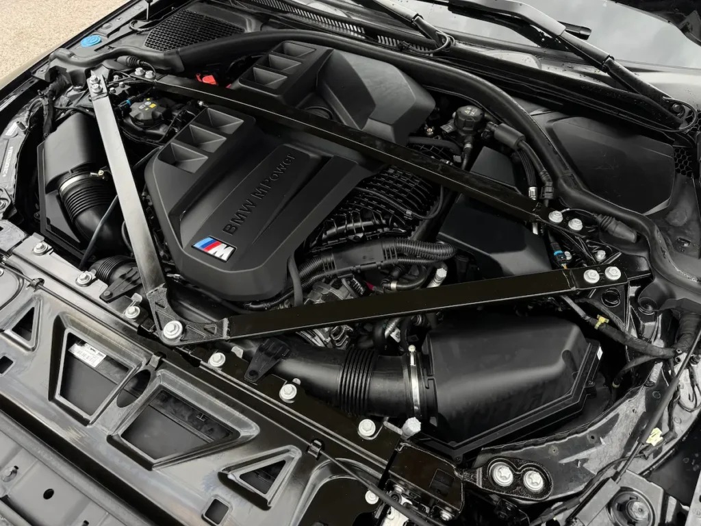 BMW M4 Competition S58 twin turbo engine bay with BMW M Power branding