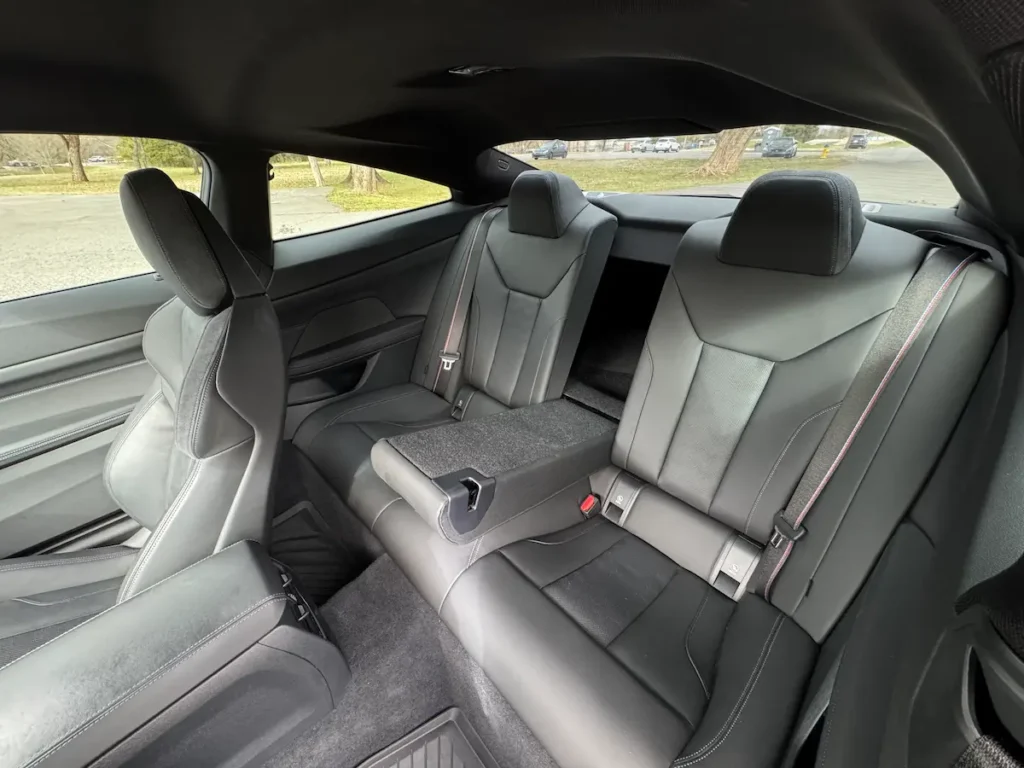 BMW M4 rear seats interior showing compact rear passenger space in performance coupe