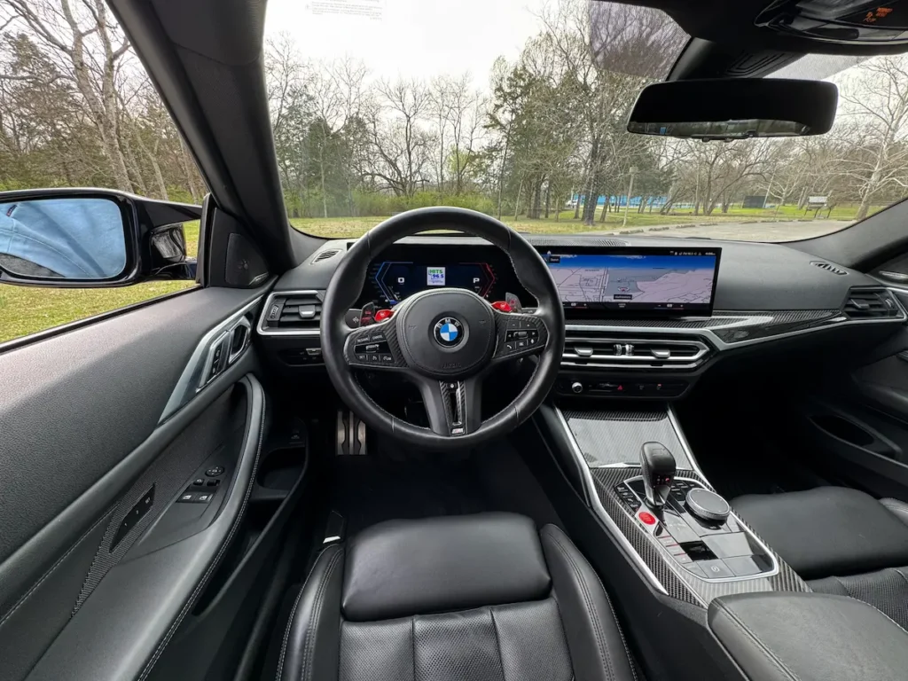 BMW M4 Competition interior cockpit with digital display and performance steering wheel