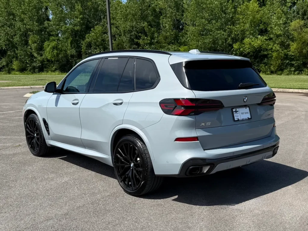 Gray 2024 BMW X5 rear three-quarter view with black wheels