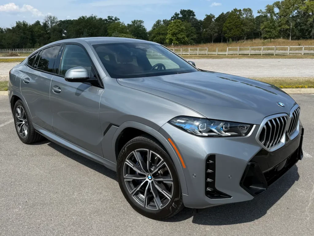 2024 BMW X6 in grey shown from the front three-quarter angle with LED headlights and sporty styling.