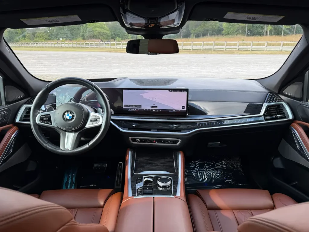 2024 BMW X6 interior front seats, digital cockpit, wide display screen, and premium finishes.