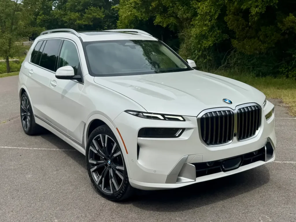 2024 BMW X7 white exterior front view showing bold grille and modern LED headlights.