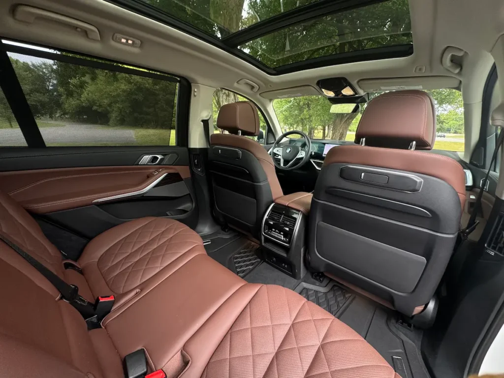 2024 BMW X7 second-row seating with quilted leather, panoramic roof, and premium finishes.