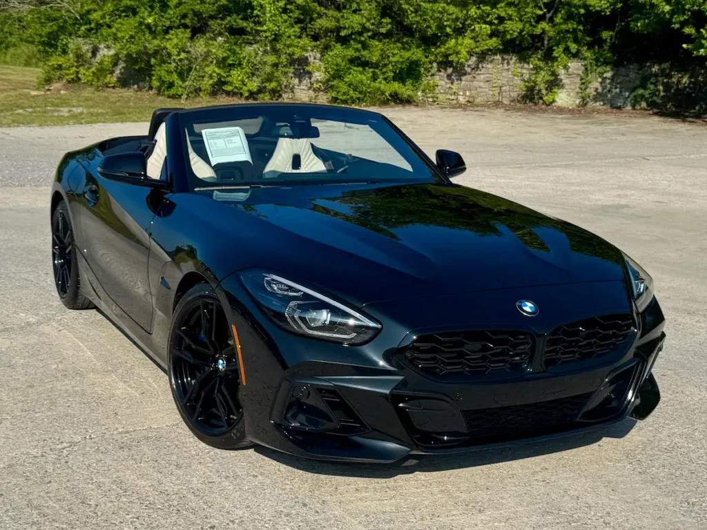 2024 BMW Z4 Roadster in black, front angle view, modern styling and M-Sport design cues.