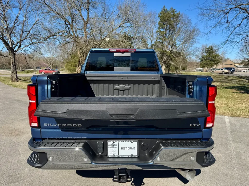 Open-bed view of a blue 2024 Chevrolet Silverado 2500HD LTZ showing the Multi-Flex tailgate.