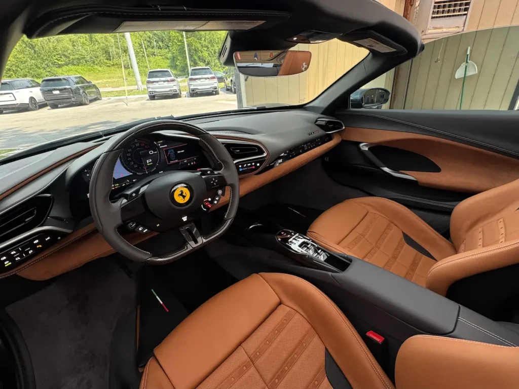 2024 Ferrari 296 GTS interior with tan seats and driver-focused cockpit