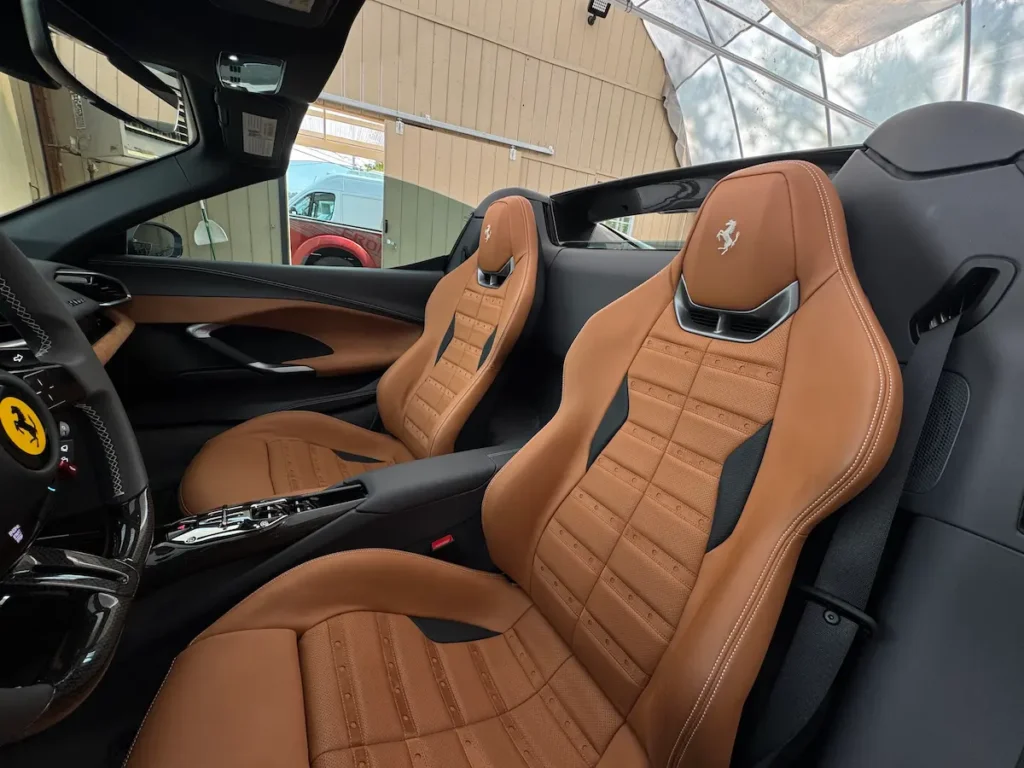 2024 Ferrari 296 GTS tan leather sport seats, exotic car interior