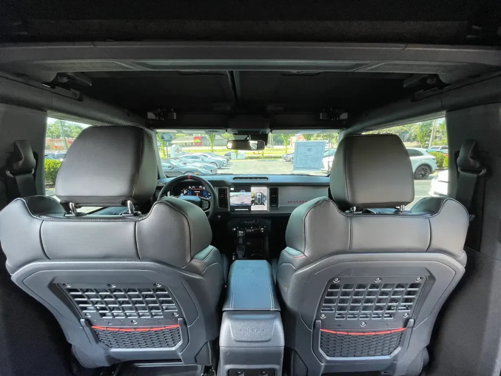 2024 Ford Bronco Raptor interior featuring rugged seating and digital controls.