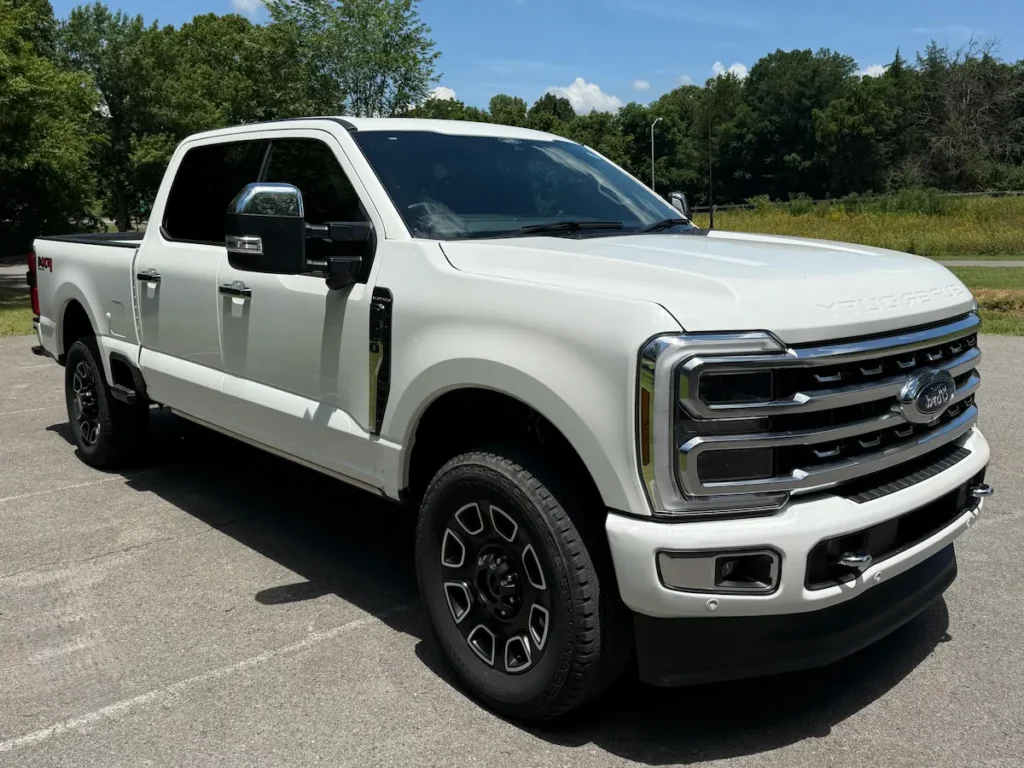 2024 Ford F-350 Super Duty white truck showcasing bold grille design and off-road stance.