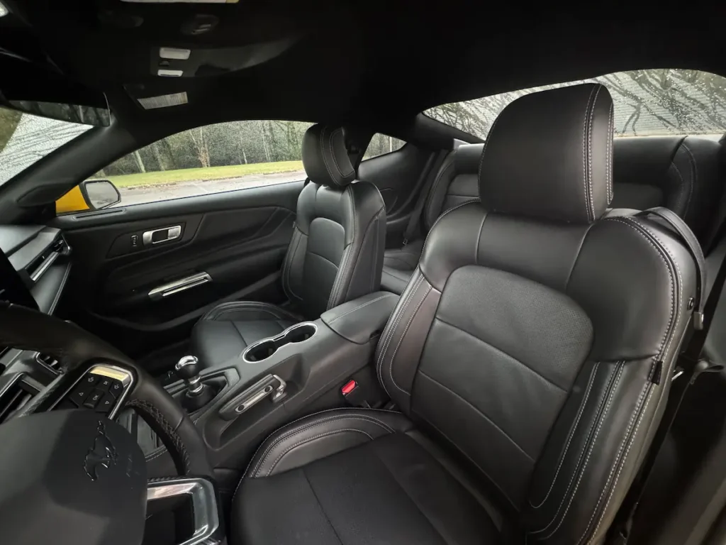 Interior front seats of a 2024 Ford Mustang GT Premium with black leather upholstery.