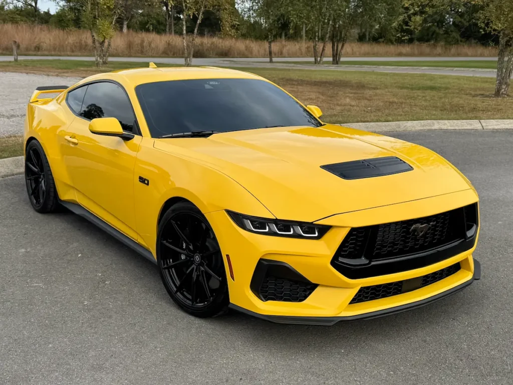 Front three-quarter view of a yellow 2024 Ford Mustang GT Premium with Performance Package.