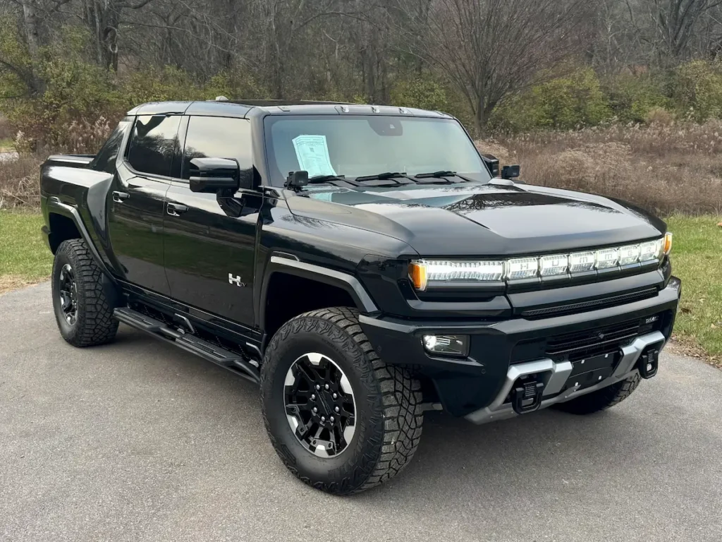 Front exterior of a black 2024 GMC Hummer EV pickup at AutoPro Nashville.
