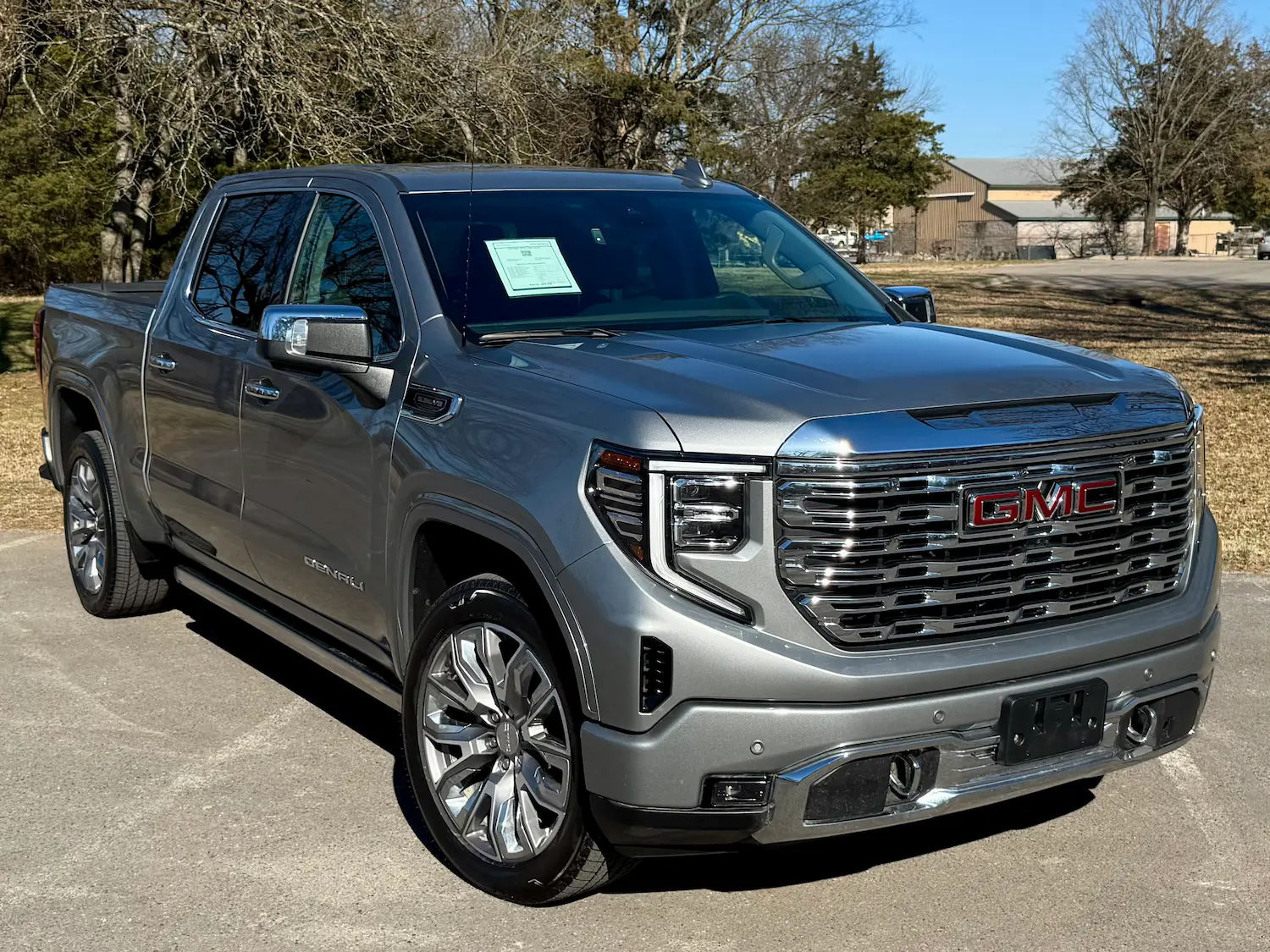 2024 GMC Sierra 1500 Denali Reserve in satin gray, chrome grille, and premium wheels