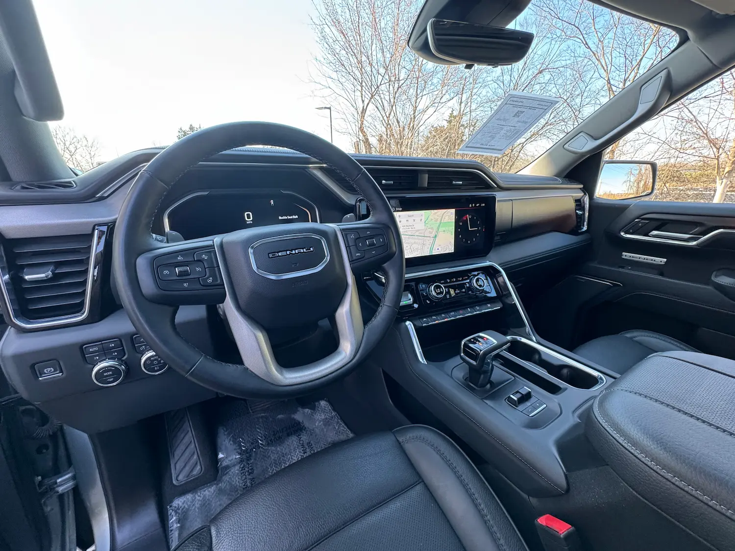2024 GMC Sierra 1500 Denali Reserve interior with leather trim, digital displays, and wood accents