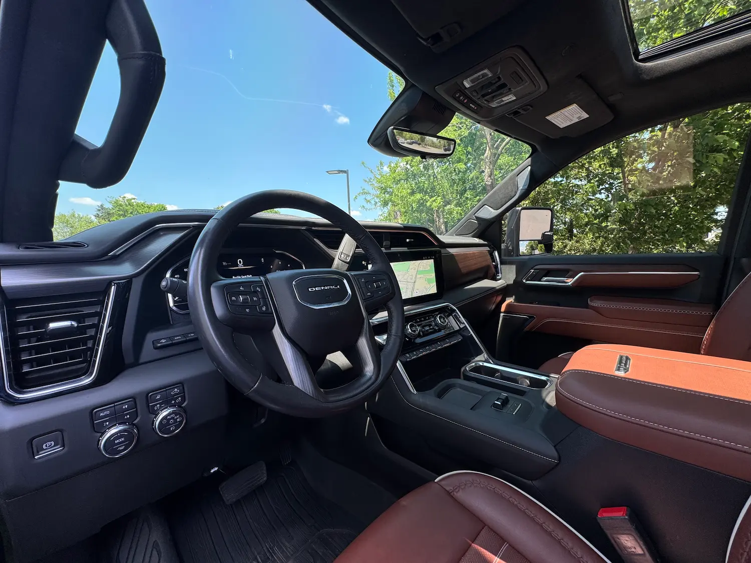2024 GMC Sierra 2500 Denali Ultimate interior with leather seats, large touchscreen, and digital driver cluster