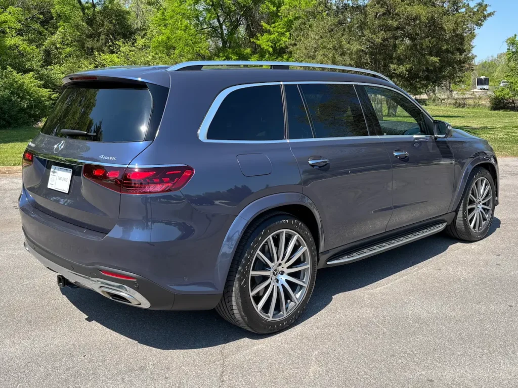Rear three-quarter view of a blue 2024 Mercedes-Benz GLS 580 4MATIC luxury SUV