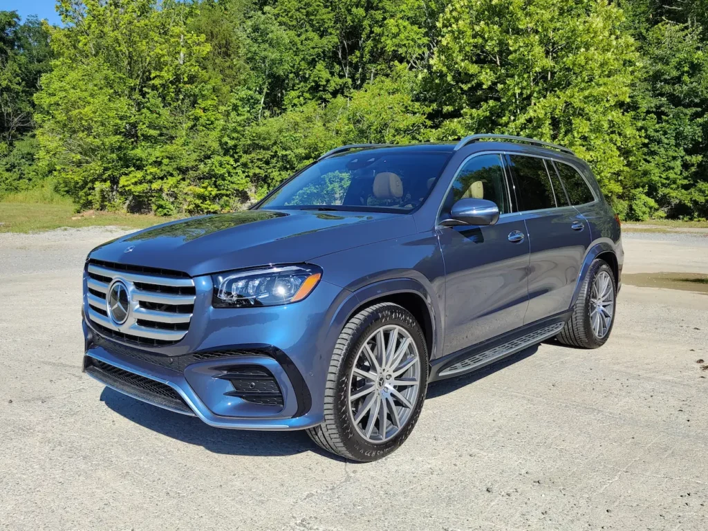 2024 Mercedes-Benz GLS 580 in blue showing its chrome grille, LED headlights, and elegant SUV stance.