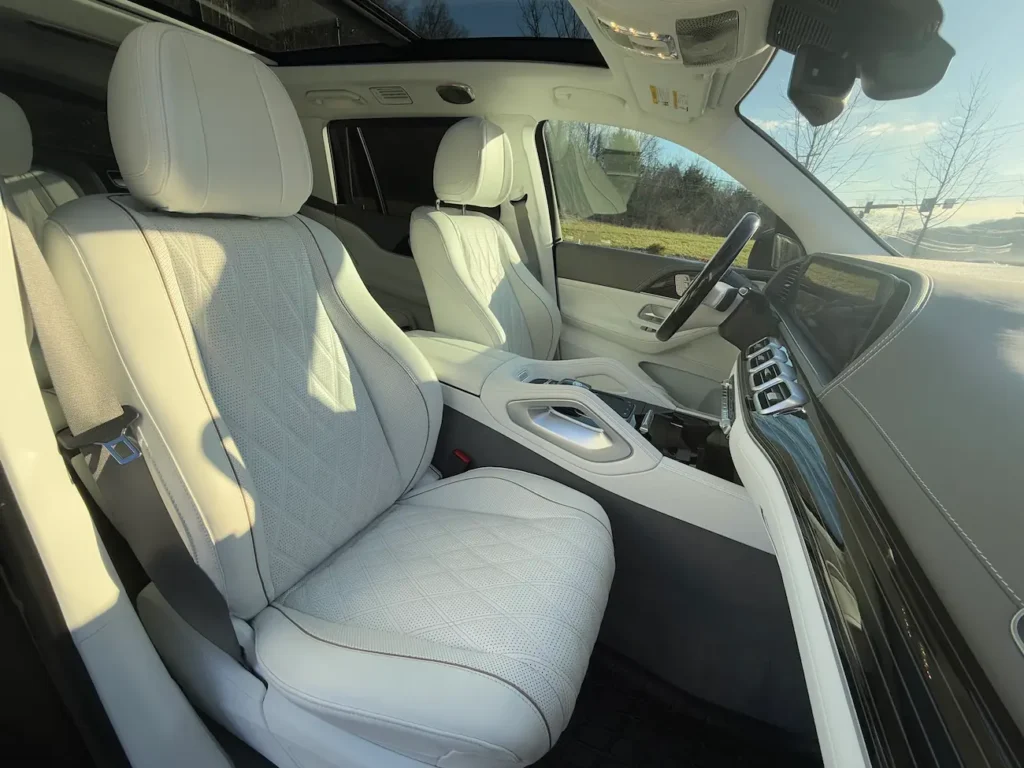Front seats of 2024 Mercedes-Benz GLS 600 Maybach with quilted white leather upholstery, premium trim, and advanced driver displays.