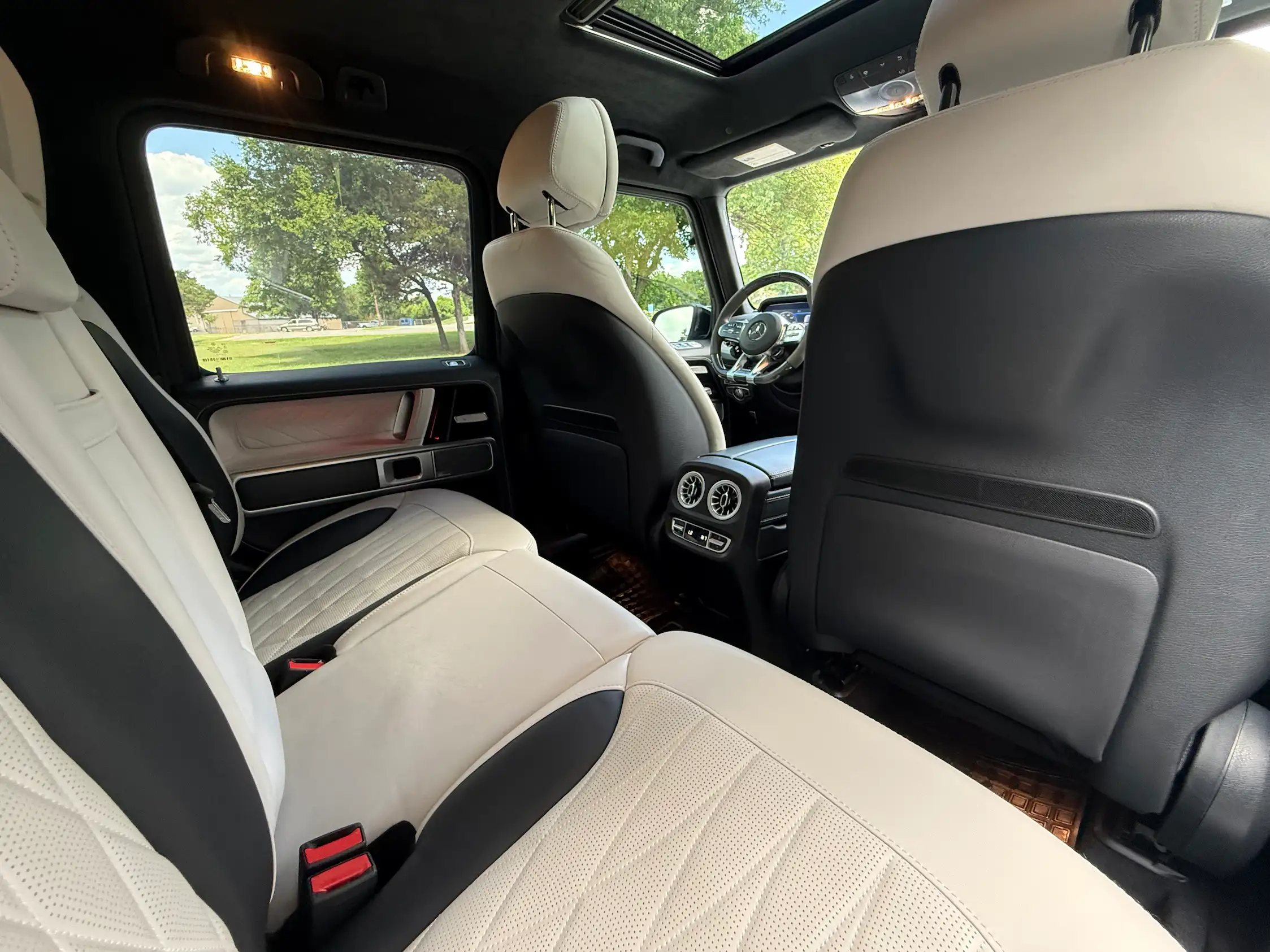 2024 Mercedes-AMG G 63 rear seats with light quilted upholstery, rear air vents and a glass sunroof.