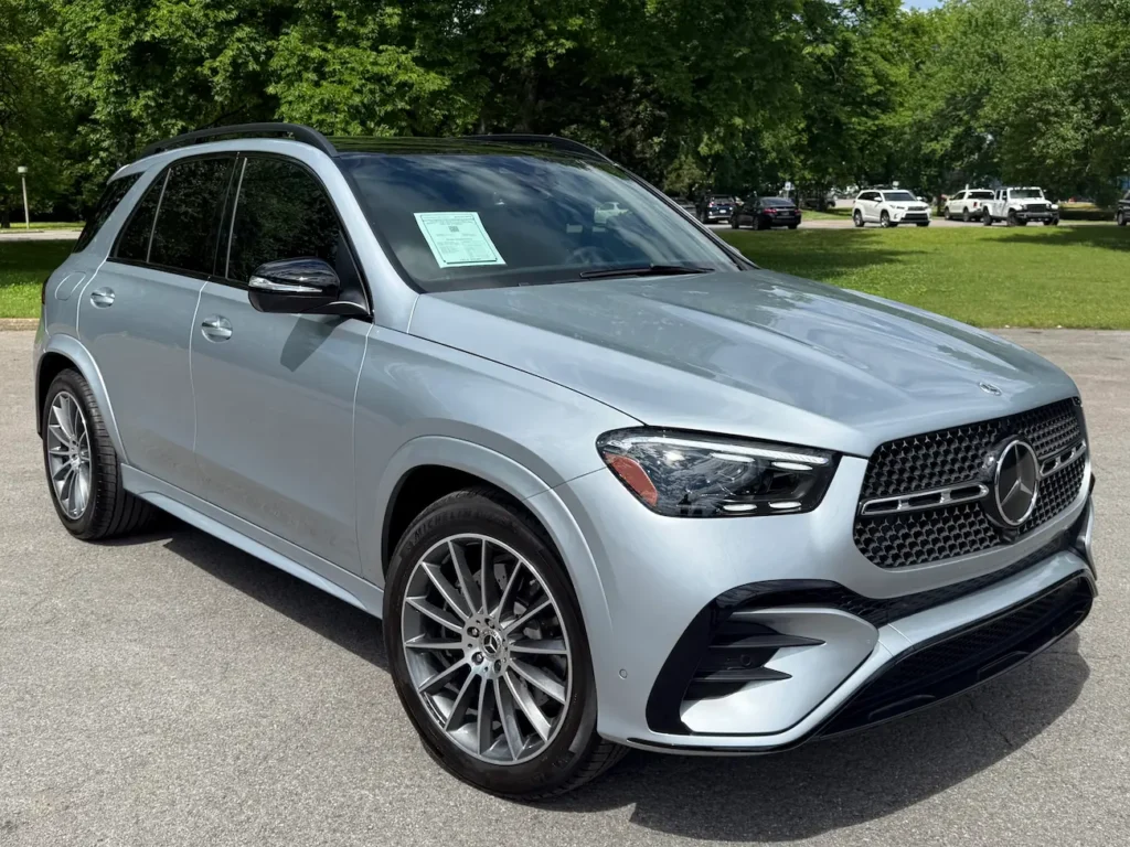 2024 Mercedes-Benz GLE 450 front angle view in silver showing AMG grille and LED headlights.