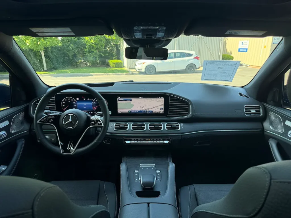 2024 Mercedes-Benz GLE 450 interior front cabin with black leather seats, steering wheel, and dual MBUX screens.