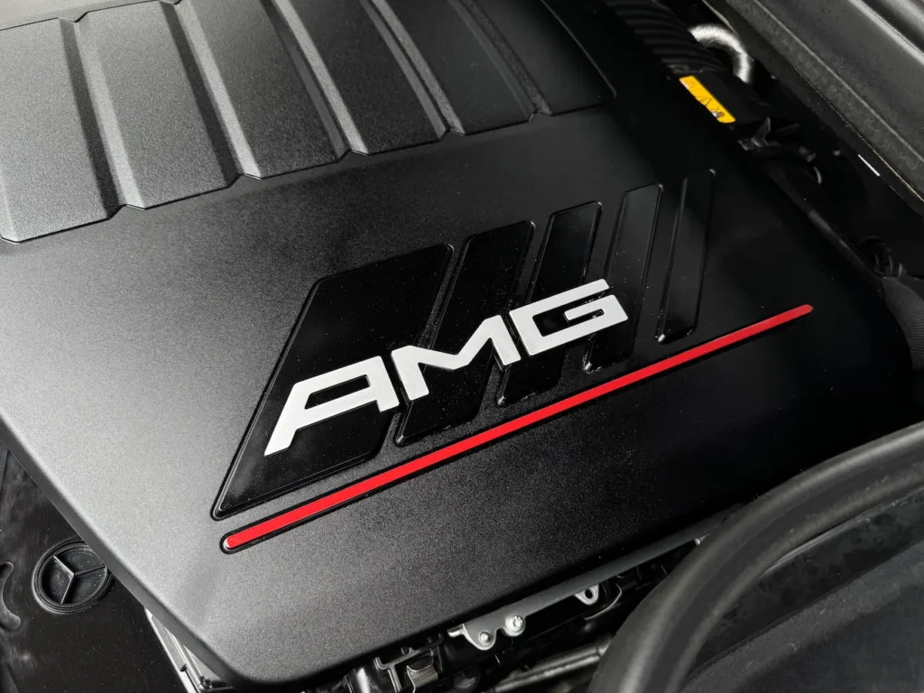 2024 Mercedes-Benz GLE 53 AMG engine cover featuring AMG logo and red accent line.