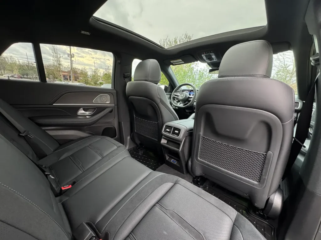 Rear seats of 2024 Mercedes-Benz GLE 53 AMG Coupe with black leather upholstery and panoramic sunroof.